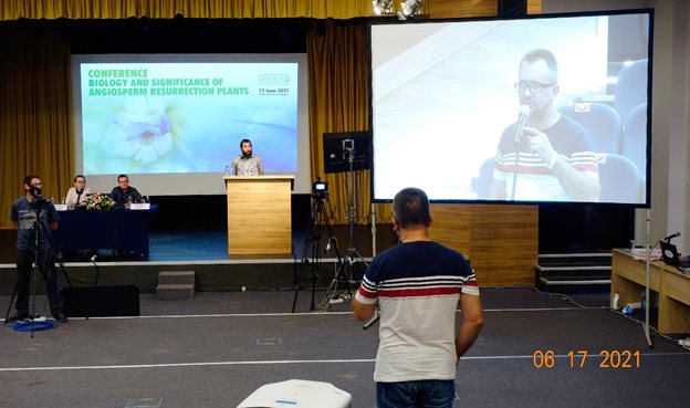 Mihail Angelov at the lectern during a question and answer session