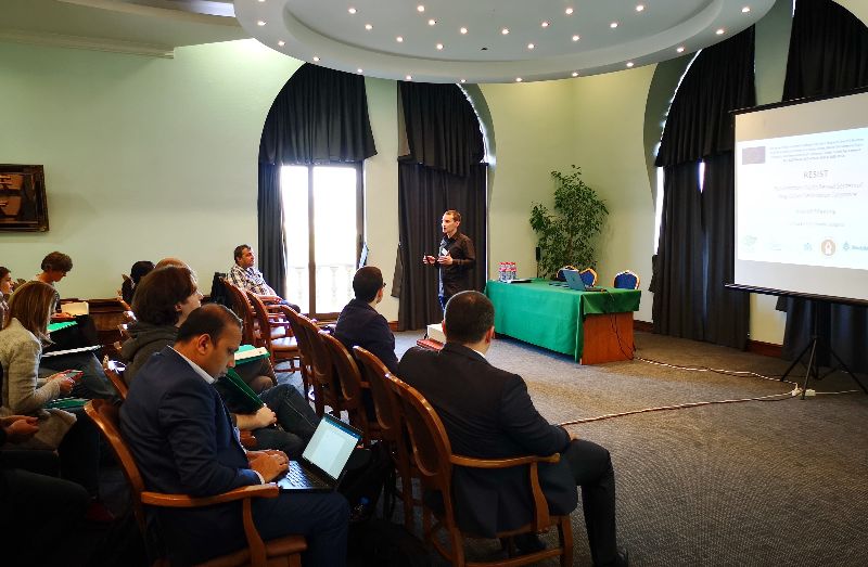 Participants seated in the meeting hall during a presentation